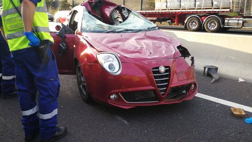 The Alpha Romeo was hit by the bucket, causing the car to roll. (NSW Police)