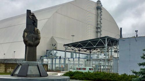 A safe confinement structure  surrounds the sarcophagus built around the stricken reactor immediately after the 1986 disaster.