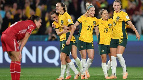Australia celebrates after beating Denmark.