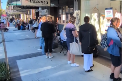 Bargain-hunting brides queue for a charity shop's wedding dress sale