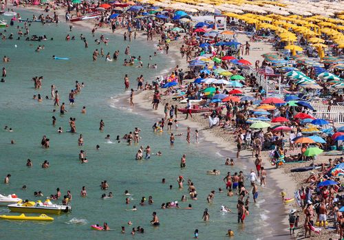 People cool off at Mondello beach, during a heatwave across Italy, in Palermo, Italy.