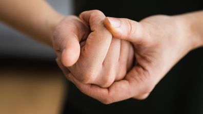 Person cracking knuckles.