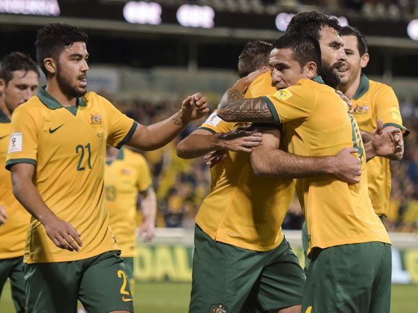 Socceroos captain Mile Jedinak (centre) celebrates with Tim Cahill after scoring against Kyrgyzstan. (AAP)