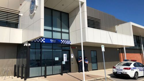 Officers outside Cockburn Police Station, which was temporarily closed following the death.