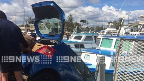Two elderly women rescued from car dangling off Melbourne jetty