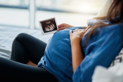 Closeup shot of pregnant woman holding an ultrasound scan
