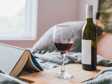 Wine glass and bottle at bedside