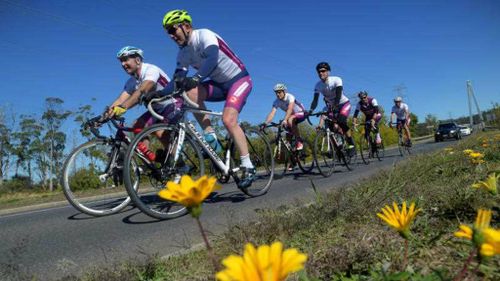 Far from the NSW election, pollie pedalling Abbott on his bike in Tasmania