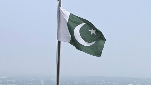 A Pakistani flag flies on a lookout in Islamabad