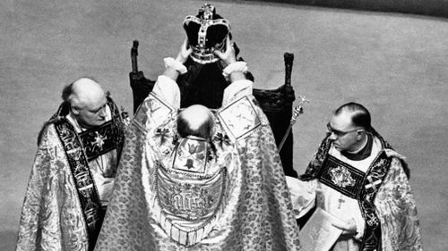 June 2, 1953: The Archbishop of Canterbury holds the ritual crown of England, the crown of St. Edward, over the head of Queen Elizabeth II, prior to the actual crowning at the coronation ceremony in Westminster Abbey, London. (AAP)