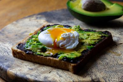 Toast with avocado and poached egg and Vegemite