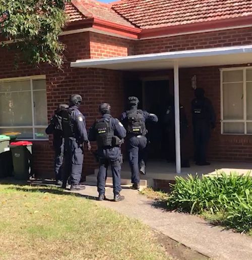 Police storm a home in Mortdale during the raids. Picture: NSW Police