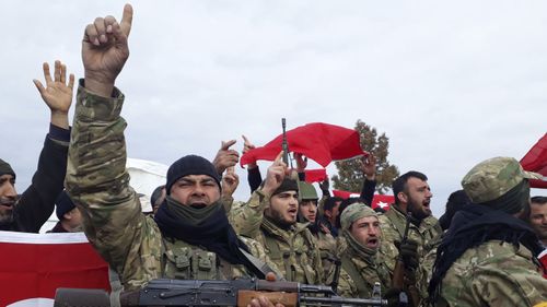 Turkey-backed Free Syrian Army fighters shout slogans before heading towards the Syrian border, in Kirikhan, Turkey, Sunday, Jan. 21, 2018. Photo: AP