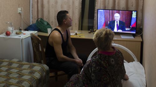 People from the Donetsk and Luhansk regions, the territory controlled by a pro-Russia separatist governments in eastern Ukraine, watch Russian President Vladimir Putin's address at their temporary place in Rostov-on-Don region, Russia.