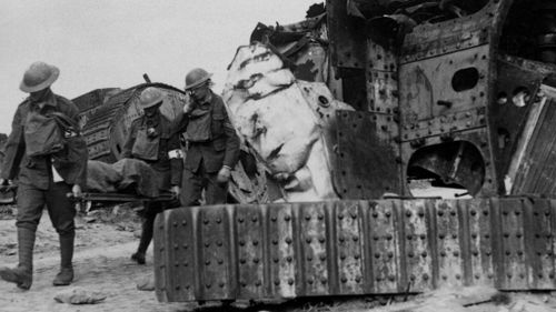 The wounded at Villers-Bretonneux in France are carried past destroyed tanks. (Getty)