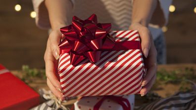 Woman holding wrapped Christmas present 2