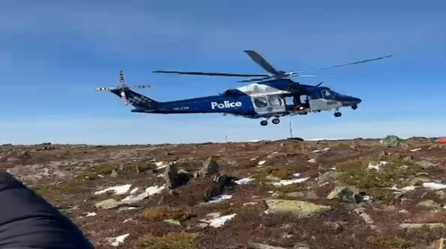 The Victoria Police chopper lands connected Mount Bogong.