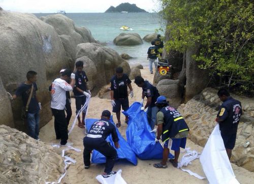 Thai officers near where the bodies of two British tourists were found on Monday. (Picture: AAP)
