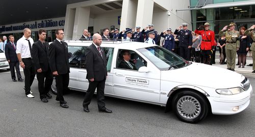 The coffin of Detective Senior Constable Damian Leeding is driven to the Gold Coast Convention Centre, Tuesday, June 7, 2011.  Picture: AAP