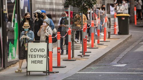 People queuing outside the COVID testing site on Bourke Street in Melbourne. 