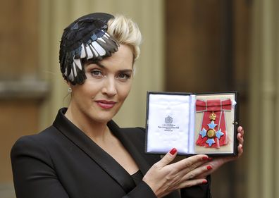 British actress Kate Winslet displays her CBE, for services to drama, which was awarded to her by Queen Elizabeth II, during an Investiture ceremony at Buckingham Palace in central London, Wednesday Nov. 21, 2012. (AP Photo/ John Stillwell/Pool)