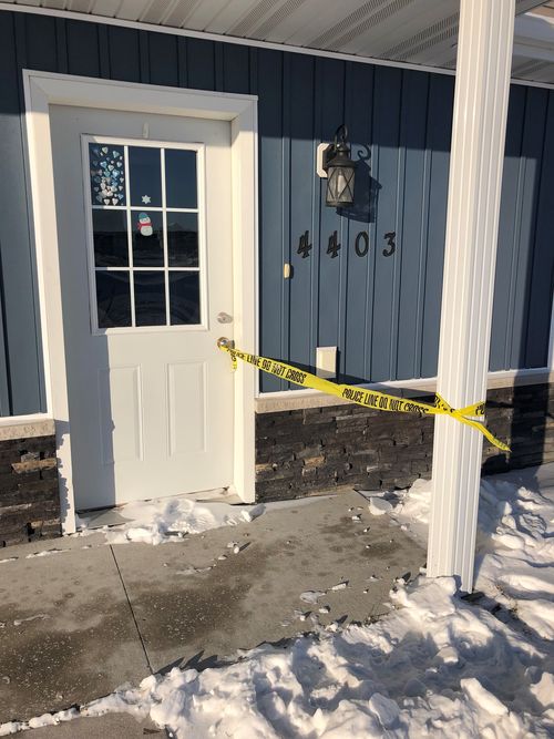 Police tape remained attached to the door of this twin home in Moorhead, Minnesota.