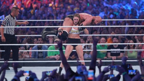 WWE newcomer Ronda Rousey putting veteran Triple H into a fireman's carry at Wrestlemania this year. Picture: Supplied