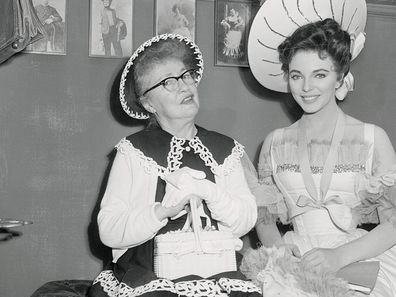 Evelyn Nesbit (left) famed Gibson girl and stage beauty of the early 1900's, with British actress Joan Collins on the set of 'The Girl in the Red Velvet Swing'.