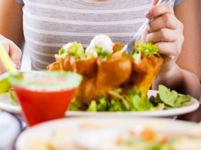 Woman eats Mexican taco salad