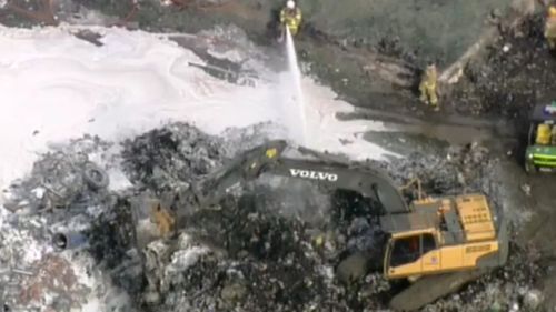 Fire crews used excavators to pull apart recycling, in order to fight the blaze. (9NEWS)
