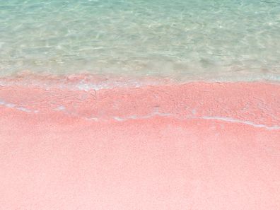Pink sand and turquoise pristine water one Balos beach  in Crete, Greece