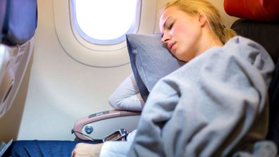 Woman sleeping on plane