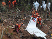 Search and rescue workers search through debris at the China Eastern flight crash site in Tengxian County in southern China&#x27;s Guangxi Zhuang Autonomous Region on March 24, 2022.