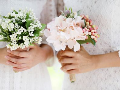 Girls holding wedding bouquet