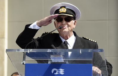 Gavin MacLeod, an original cast member in the television series "The Love Boat," salutes the crowd as he speaks at a Friends of Hollywood Walk of Fame honorary star plaque ceremony for the cast and Princess Cruises.