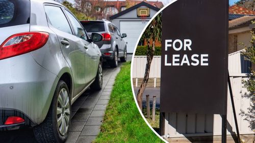 Cars parked in driveway next to For Lease sign