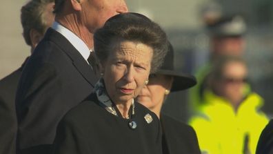 Princess Anne watches on as her mother's coffin is loaded onto the RAF plane. 