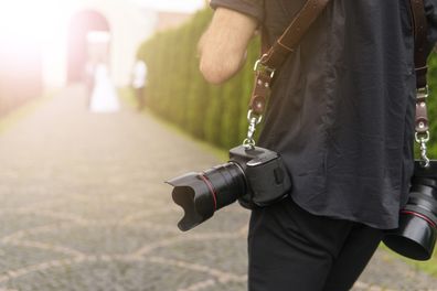 Wedding photographer follows bride and groom