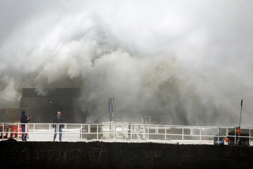 Waves crash over the harbour on October 19, 2023 in Stonehaven, Scotland. 