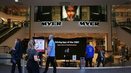 Shoppers queue outside Myer in the Pitt Street, Sydney.