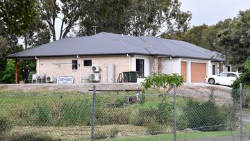 Police are seen at a house on Muller Road in the Brisbane suburb of Taigum