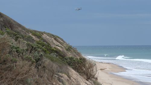 A police helicopter above the beach today. (AAP)