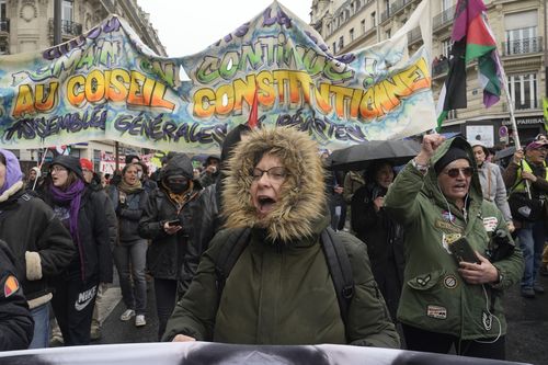 People demonstrate Friday, April 14, 2023 in Paris. 
