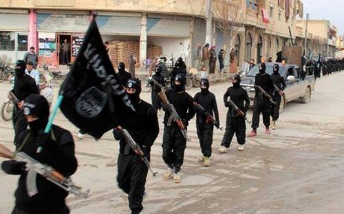 2014 photo of Islamic State fighters marching in Raqqa, Syria. Photo: AAP