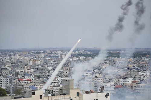 Rockets are launched by Palestinian militants from the Gaza Strip towards Israel, in Gaza, Saturday, Oct. 7, 2023.  