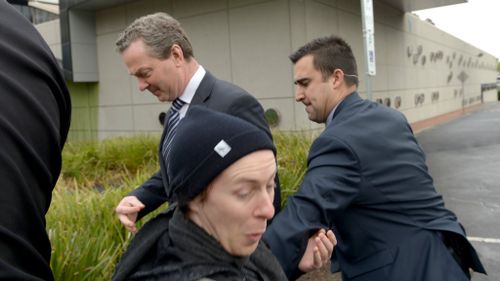 Mr Pyne is escorted inside by security. (AAP)