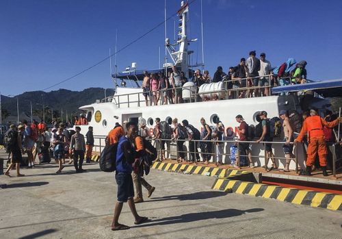 Thousands of desperate tourists have been trying to access ferries away from the islands. Picture: AAP.