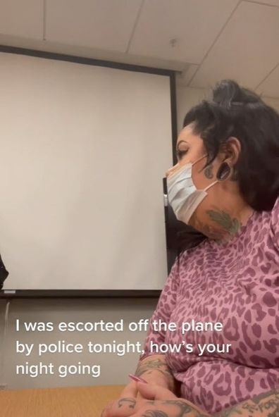 Woman police interview escorted from flight