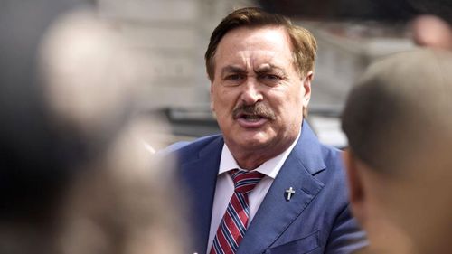 Mike Lindell, chief executive officer of MyPillow, talks to reporters before attending a rally in downtown Denver