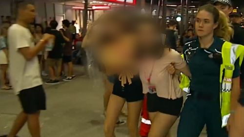 Police dealt with a large crowd on Schoolies day six. (9NEWS)